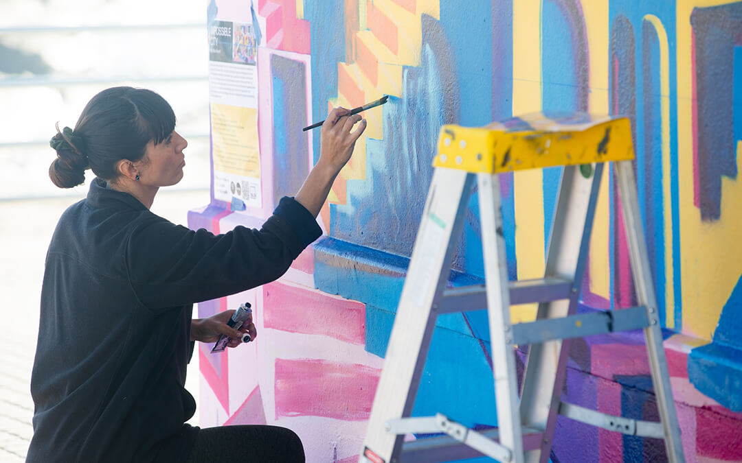 Mika Revell (Little Pink Pills) creating her mural for Blok and SJ Artists on the Sea Point promenade